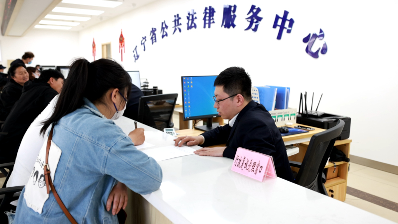 配文1：行政复议受理窗口工作人员接待复议申请人。