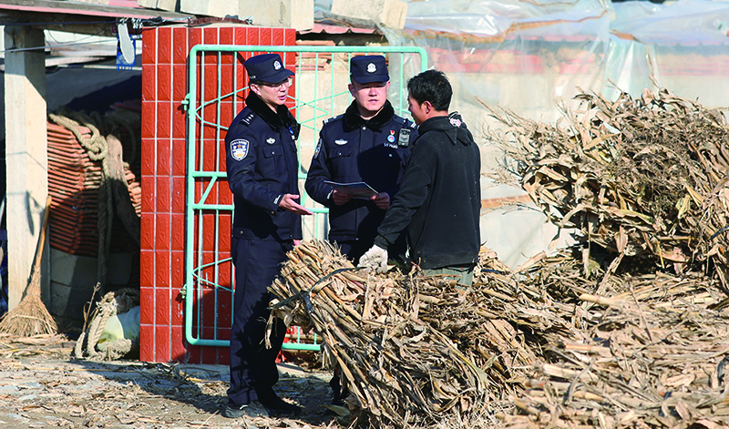 夏远亮（中）在村中走访