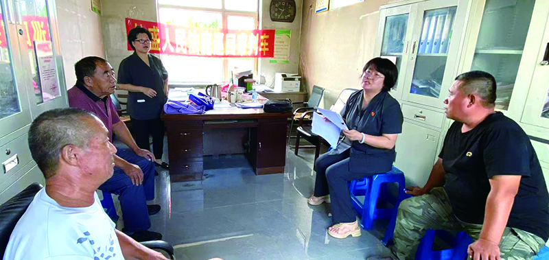 刘芳庭长(右二)在八一红菱街道某村讲解土地承包相关法律法规