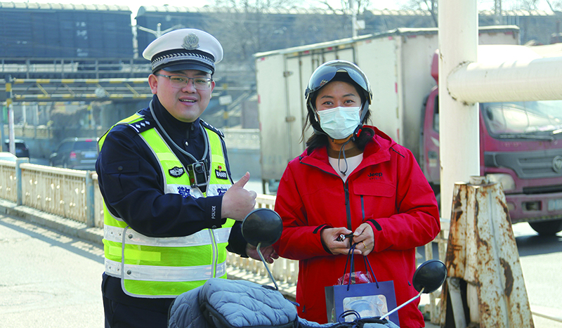 向遵规守法群众赠送“交警小熊”