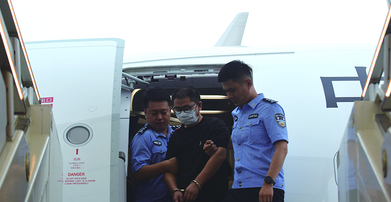 高某某被警方带下飞机 本报记者 王聪 摄